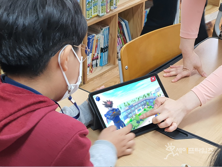 ▲ 초등학생이 '번개맨과 친환경 번개파워' 앱에서 포스코의 스마트 하우징 기술을 활용해 무너진 학교를 재건하고 있다. ⓒ 포스코