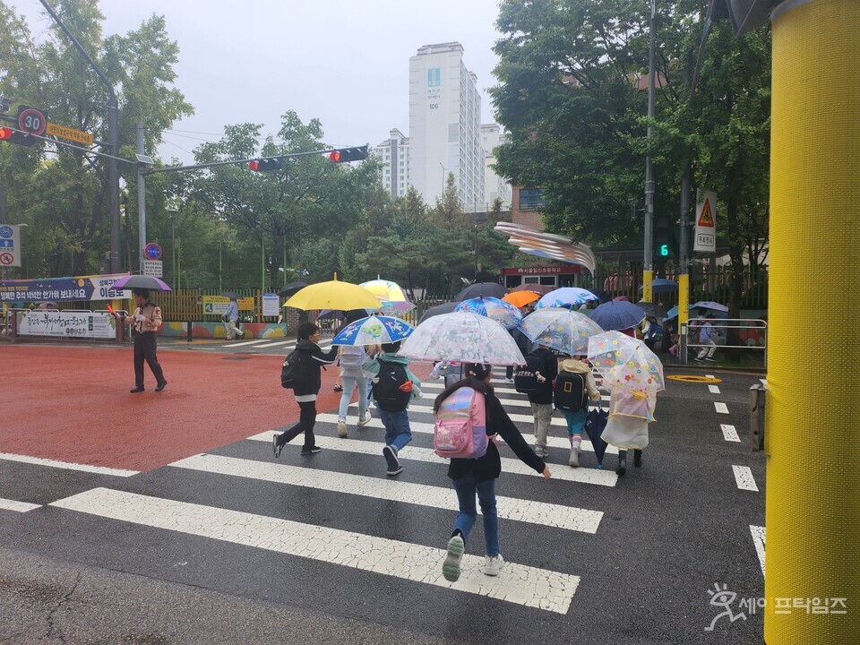 ▲ 비가 오는 날에 서울 성북구 초등학생들이 우산을 쓰고 등교하고 있다. ⓒ 세이프타임즈