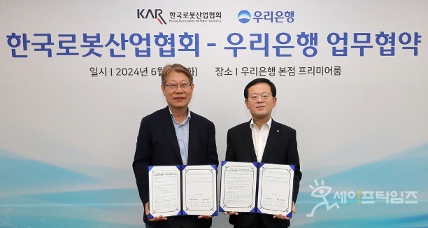 ▲ 조병규 우리은행 은행장(오른쪽)과 김진오 한국로봇산업협회 회장이 로봇산업 발전을 위한 업무협약을 하고 있다. ⓒ 우리은행